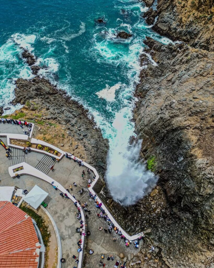 Excited tourists witnessing the La Bufadora blowhole eruption, the best private shore excursion in Ensenada for cruise passengers.