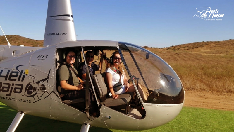 Private helicopter tour flying over Tijuana Mexico coastline and Baja California scenic highway at sunset