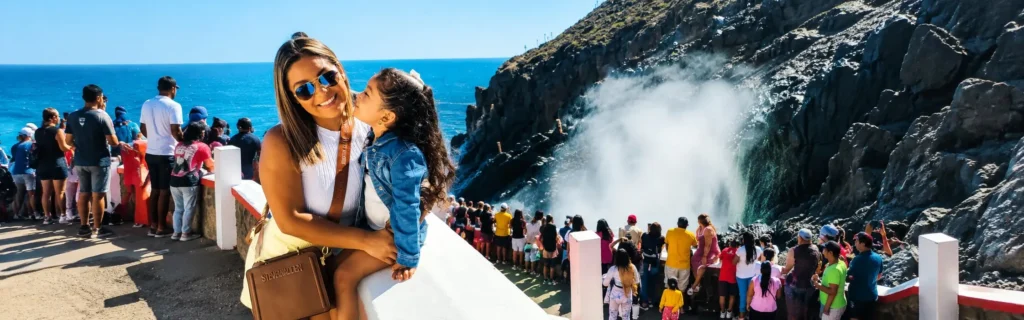 Family enjoying the famous La Bufadora blowhole during an Ensenada cruise ship shore excursion in Baja California, Mexico.